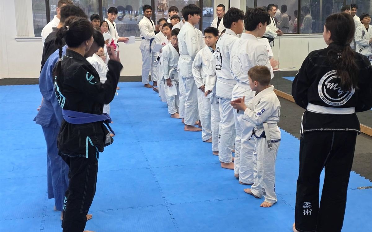 Students in gis lined up along the mat at the start of class in Carlingford