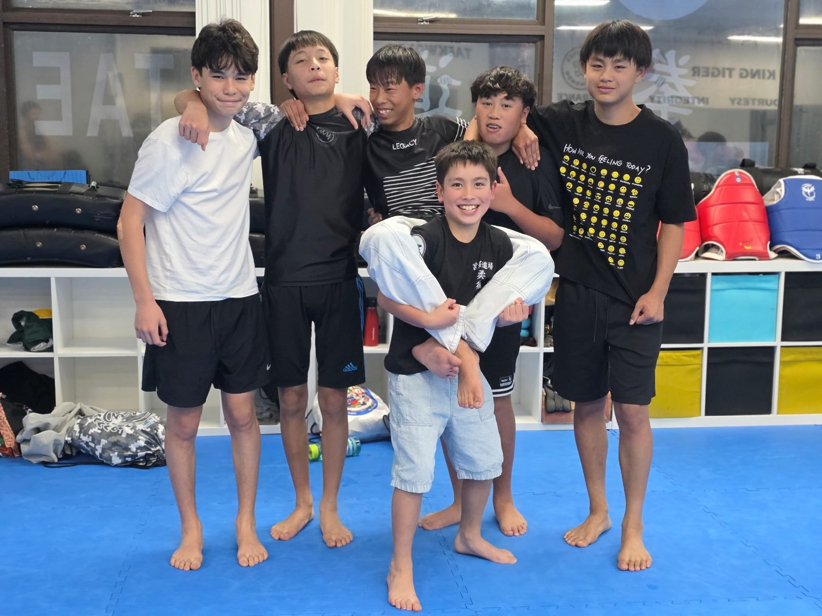 Two students working from top control on the mat