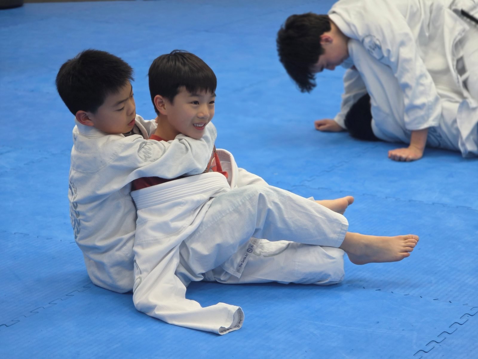 A coach guiding a young beginner through a technique one to one